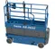 Side view of a retracted blue and gray Genie scissor lift with safety rails.