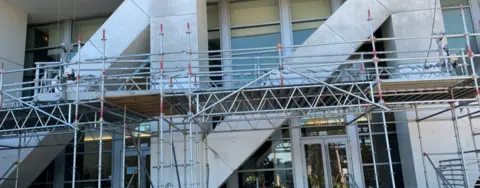 échafaudage devant des marches à l’extérieur d’un immeuble de bureaux