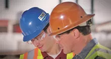 two men in hard hats on construction site