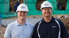 two men in hard hats on construction site