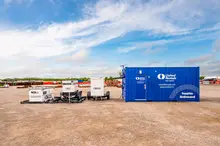 Blue Cargo Container with White Generators on Worksite